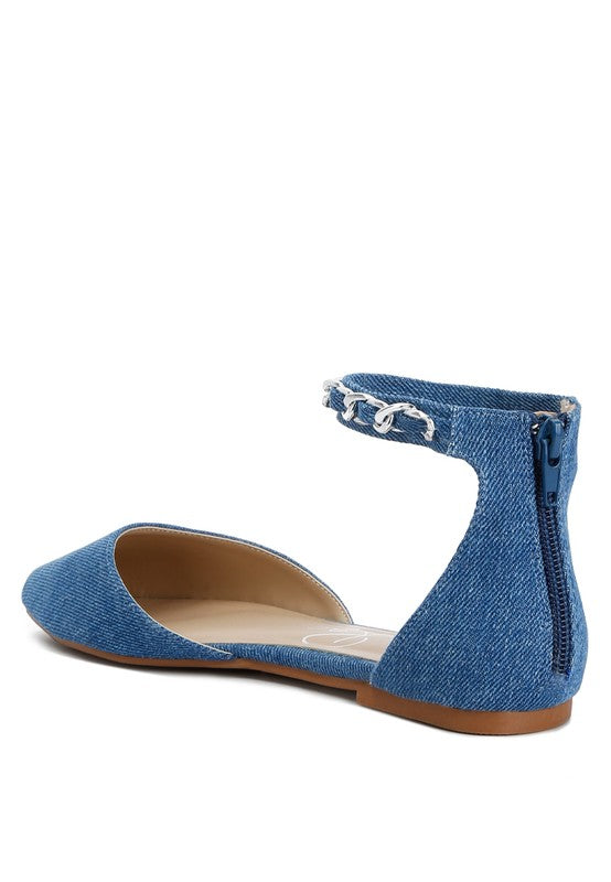 Denim flats with a pointed toe, chain ankle strap, and flat heel .