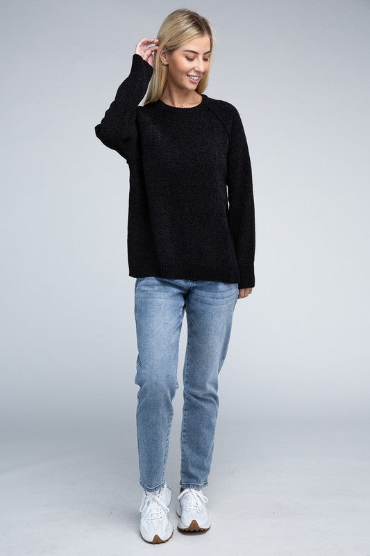 Black round neck chenille sweater with long raglan sleeves, relaxed fit, and hip-length cut.