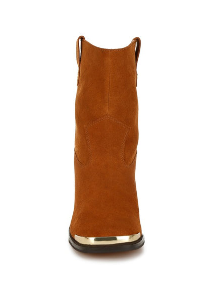 Head-on view of tan Emberly boots highlighting structured suede shape and metal toe tip.
