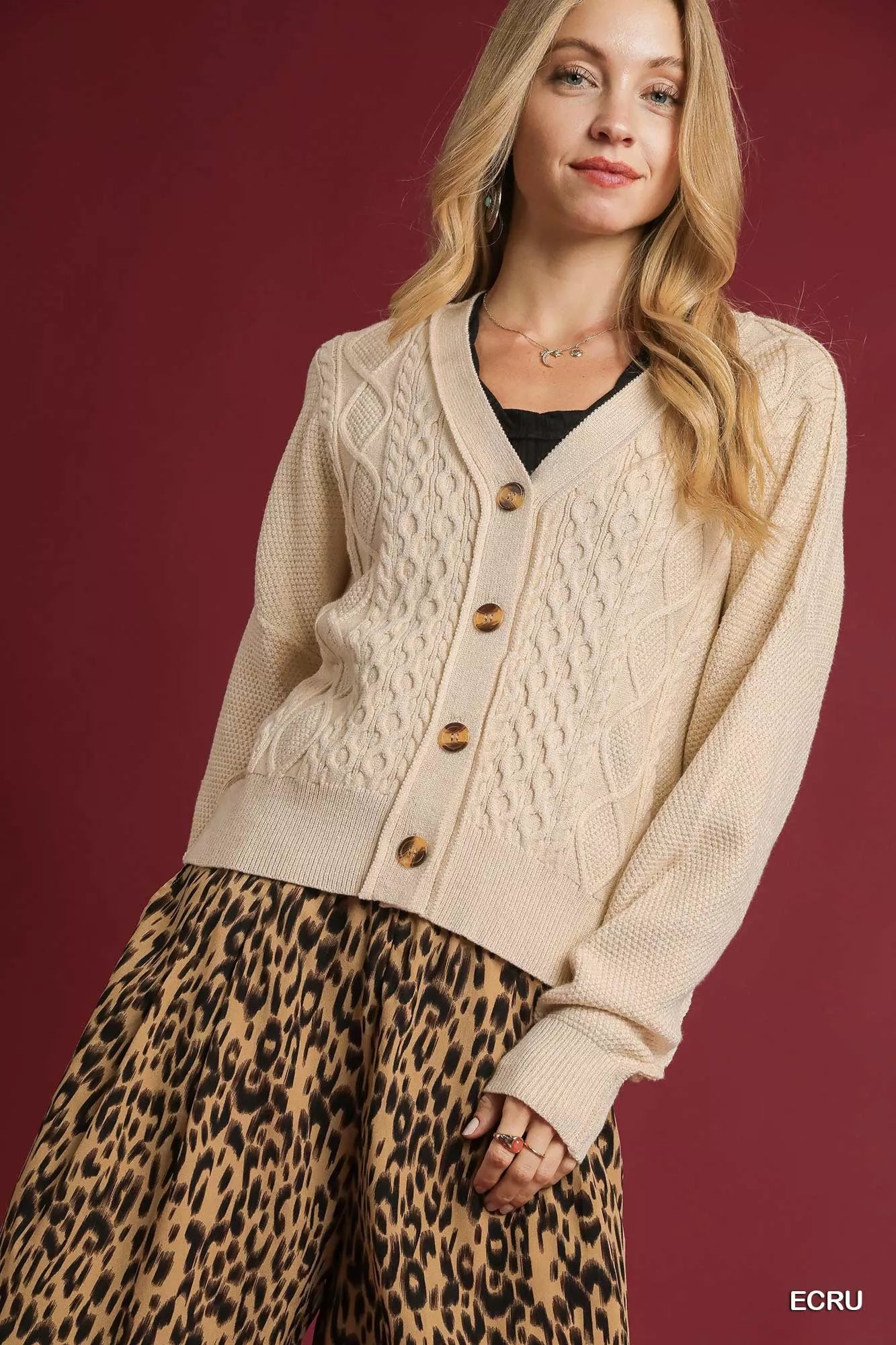 Uma Chunky Cable Knit Cardigan in Ecru – front view, cropped V-neck style with button-up design.