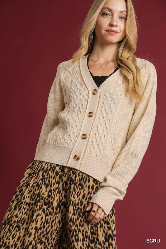 Uma Chunky Cable Knit Cardigan in Ecru – front view, cropped V-neck style with button-up design.