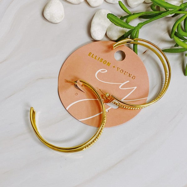 Gold Double Open Top Hoop Earrings with cubic zirconia accents displayed with Ellison + Young tag
