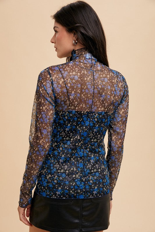 Back view of Elodie black/blue floral mesh top showing sheer mesh fabric and playful lettuce hemline.