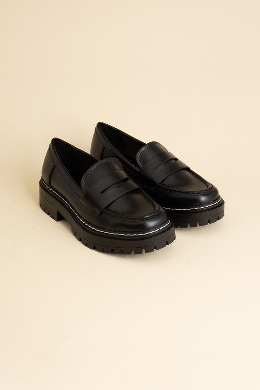 Black classic loafers with a sleek design and minimalist accents.