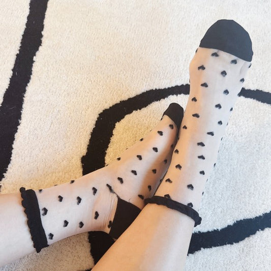 Woman wearing black Sweet Hearts Sheer Socks styled with heart pattern.