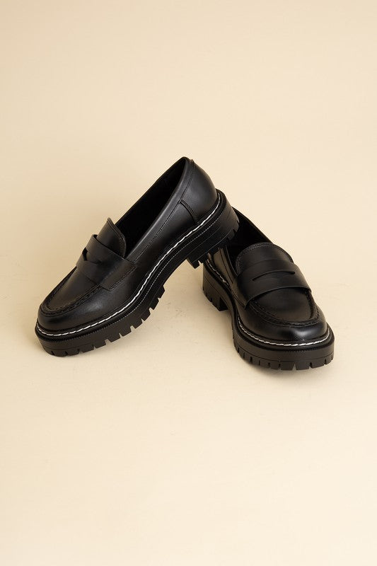 Black classic loafers with a sleek design and minimalist accents.