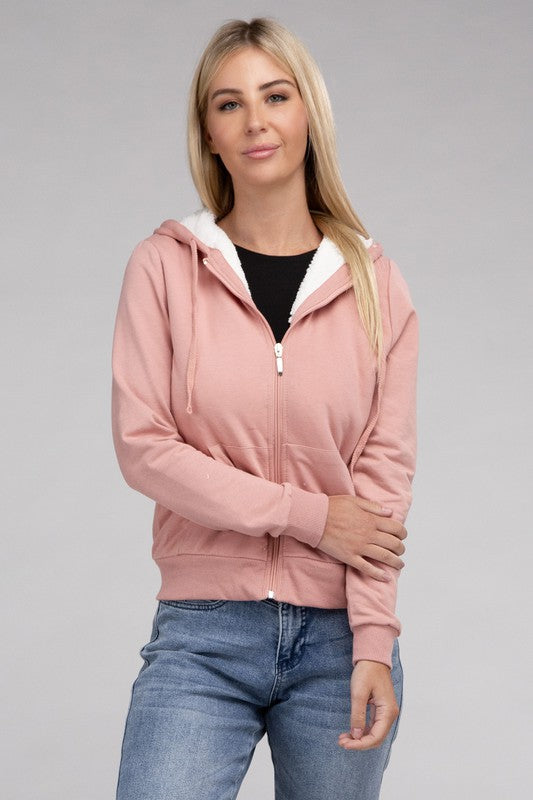 Mauve cropped zip-up hoodie with fuzzy trim, pockets, and long sleeves.