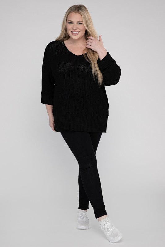 Black plus size crew neck sweater with a loose fit, side slits, long sleeves, and a cozy knit fabric for warmth.