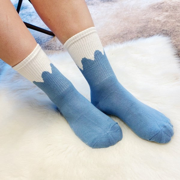 Woman wearing blue snow-capped Trendy Pattern Socks in cozy cotton blend.