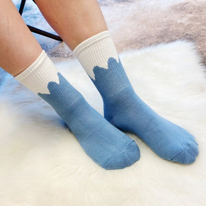 Woman wearing blue snow-capped Trendy Pattern Socks in cozy cotton blend.