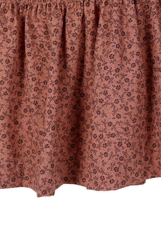 Brown floral smocked skirt with pleats, side zipper, and lining for coverage.