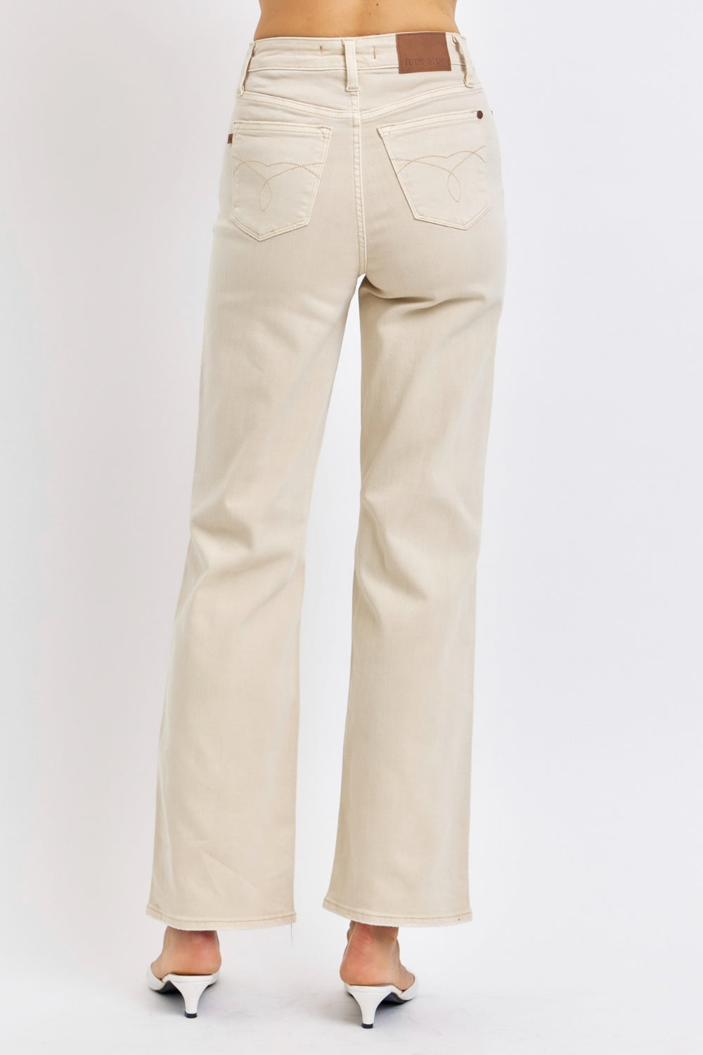 Bone-colored high-waisted wide-leg jeans with distressed details pockets, stretch denim with zip fly.