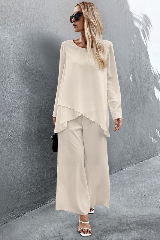 Front view of Nikita Two Piece Set in crème styled with heels and handbag