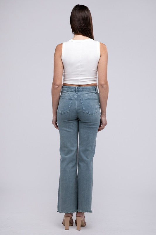 Teal acid-washed straight wide-leg pants featuring a frayed cutoff hem, zip fly closure, and a relaxed fit. Made with stretchy fabric for comfort and a unique vintage-inspired look.