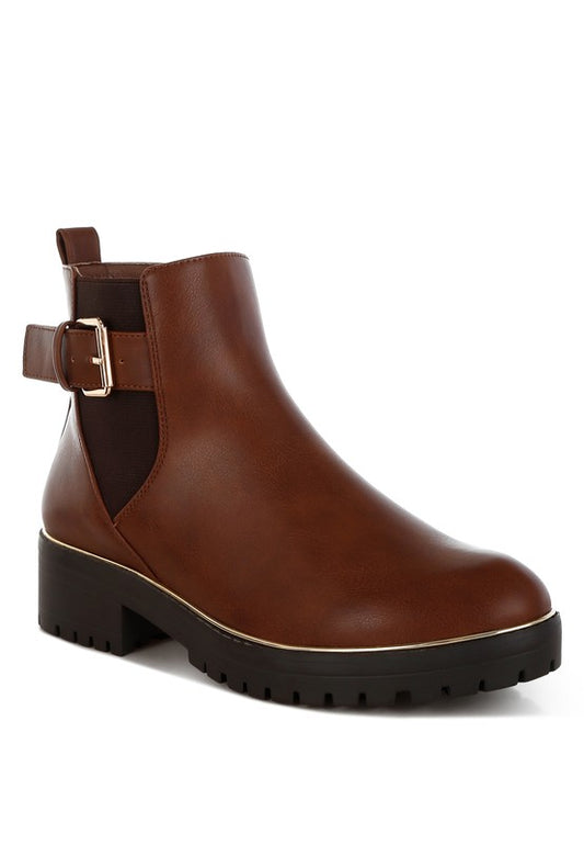 Front angle view of tan Antorin chunky buckle ankle boots with round toe and platform sole.