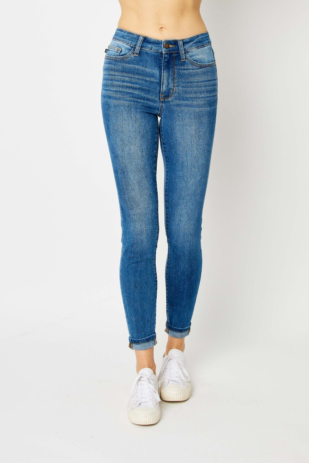 Mid-rise skinny jeans with cuffed hems and a zip fly. Medium wash with a slim fit and highly stretchy fabric.