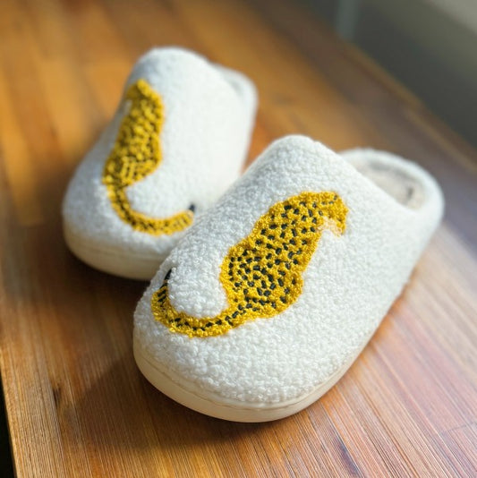 Pair of sherpa cheetah slippers shown from the front.