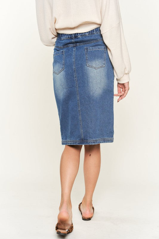 Denim button-down midi skirt with a front slit, belt loops, and back pockets. Features a high waist with an elasticized waistband in the back.