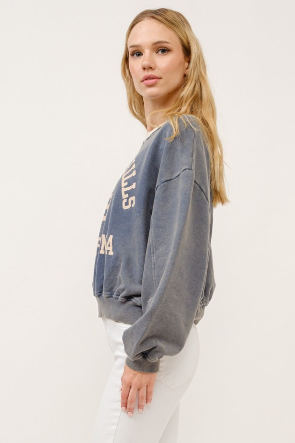 Cropped sweatshirt in stone color with "Beverly Hills 92 California" graphic text and contrast detailing.