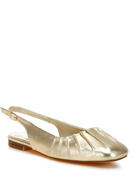 Metallic pleather flat slingbacks with a square closed toe, adjustable pin buckle strap, and cushioned insole, available in gold.