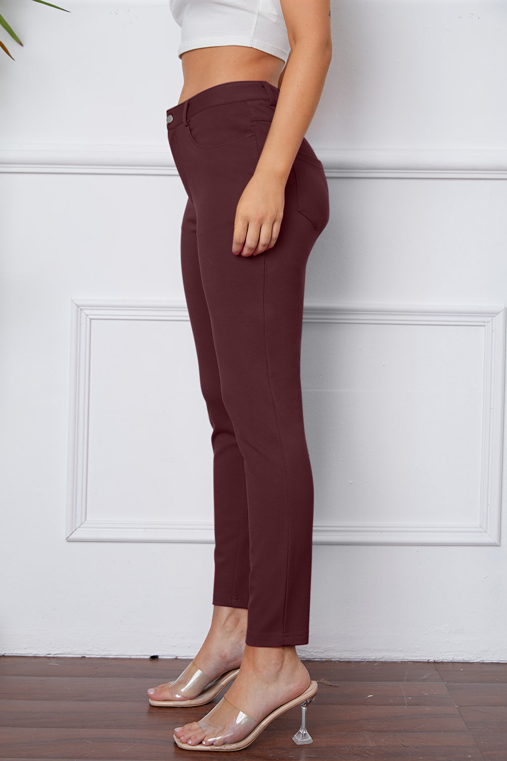 Wine stretchy high-waisted pants feature pockets, a zip fly, and belt loops. 