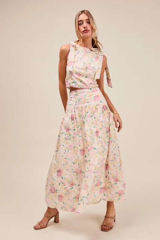 Front full body view of model in Soraya Floral Two-Piece Set with tie-shoulder crop top and tiered maxi skirt in pink floral.