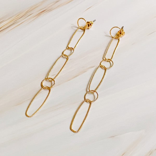Dainty Chain Link Drop Earrings in gold displayed on soft neutral background