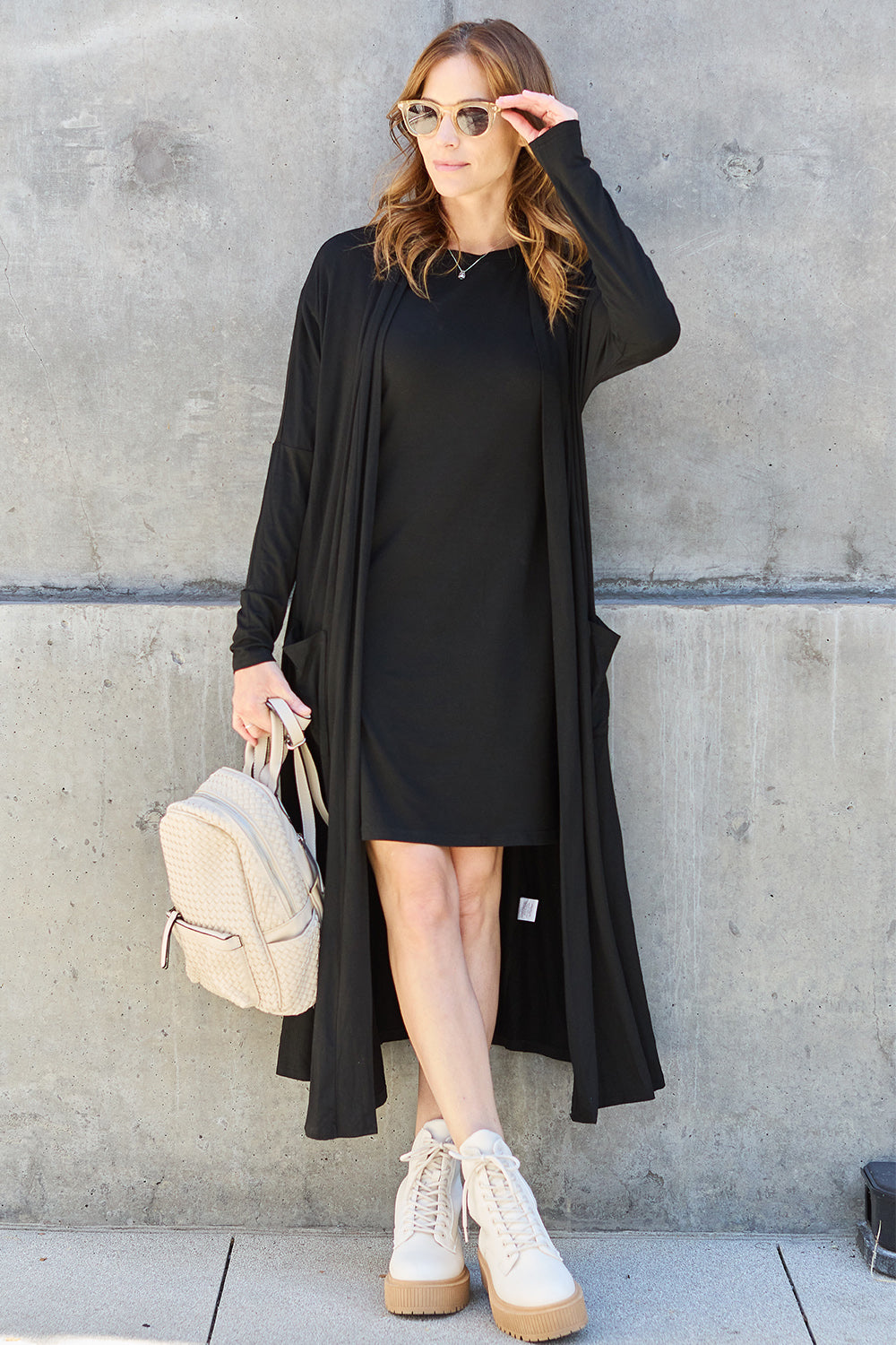 Black open-front long-sleeve cover-up with a flowy design and pockets, perfect for layering on breezy days.