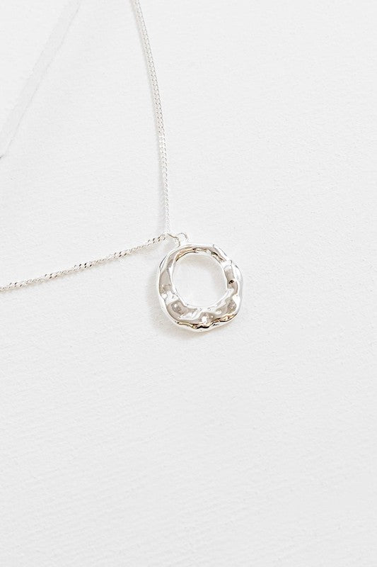 Flat lay of Charming Circle Necklace in Silver with textured pendant