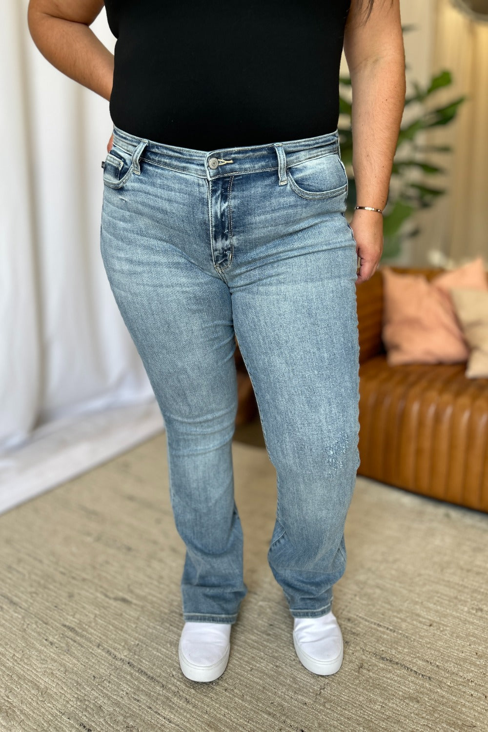 Medium Rise Bootcut Jeans by Judy Blue in light wash. Flattering medium rise, slight flare silhouette, moderate stretch for all-day comfort. Perfect for pairing with boots or heels.