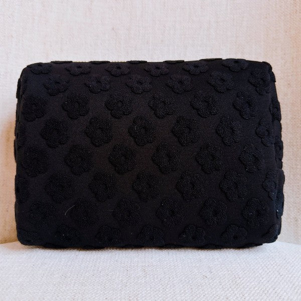Black Embossed Daisy Blossom Cosmetic Case with golden daisy zipper pull.