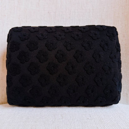 Black Embossed Daisy Blossom Cosmetic Case with golden daisy zipper pull.