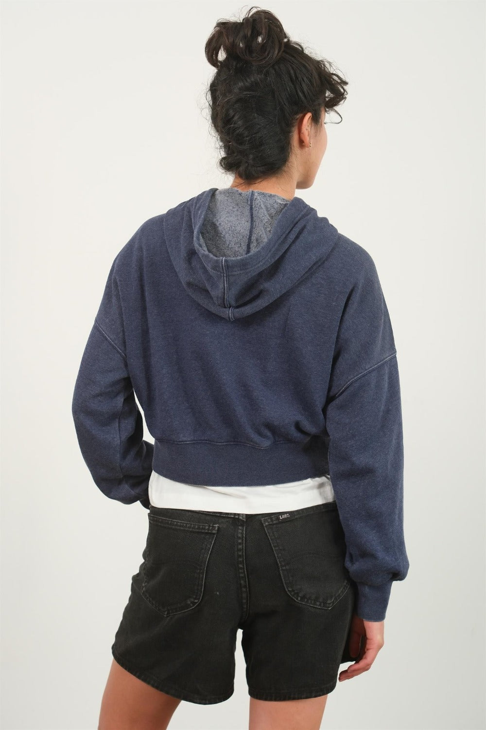 Dark navy cropped hoodie with a hood, drawstring, drop shoulder long sleeves, and a relaxed fit.