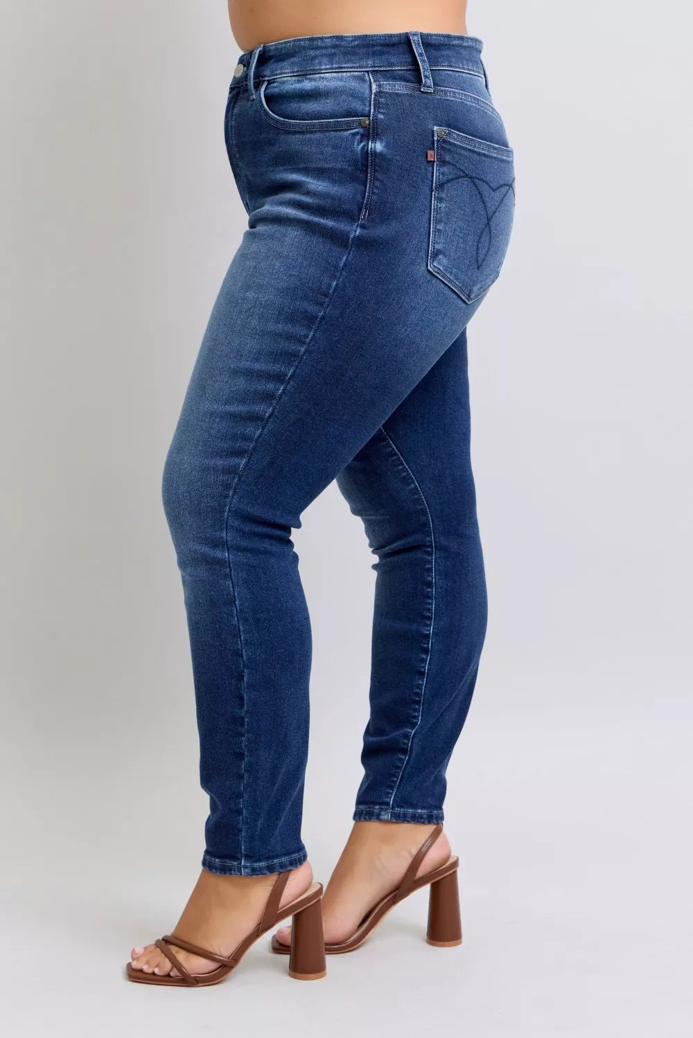 Side angle of plus size Glenda Washed Thermal Skinny Jeans highlighting slim leg silhouette.