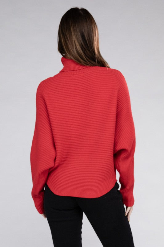 Ruby loose fitting turtleneck sweater, with ribbed knit texture, dolman sleeves, and raw hem detailing.