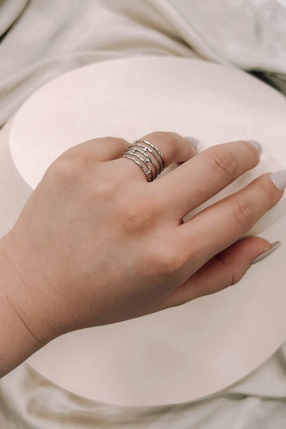 Woman’s hand wearing Twig Adjustable Ring Silver layered style.