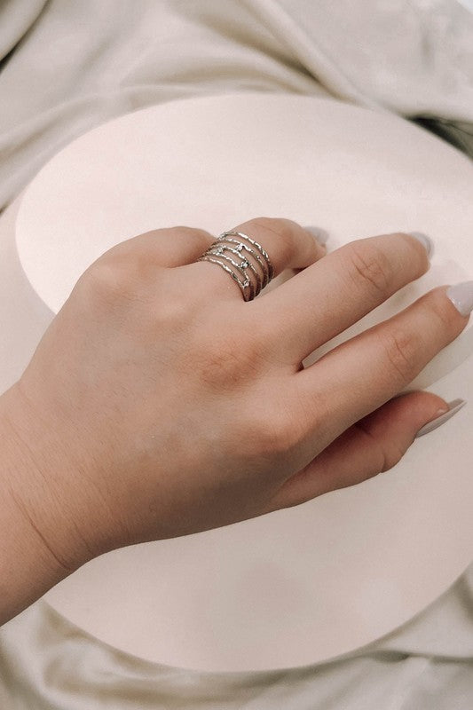 Woman’s hand wearing Twig Adjustable Ring Silver layered style.