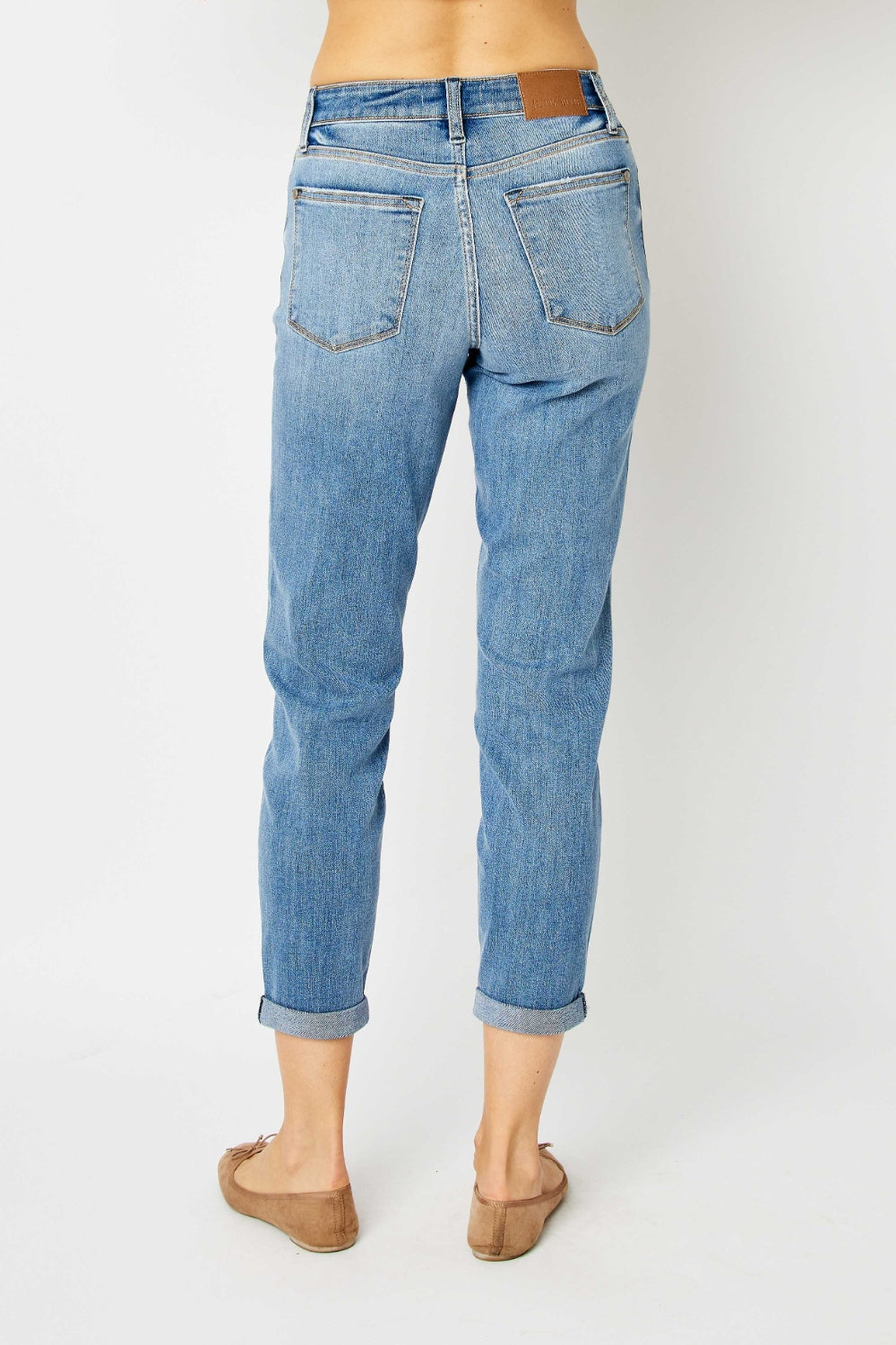 Mid-rise slim fit jeans with cuffed hems and a zip fly. Medium wash, highly stretchy fabric.