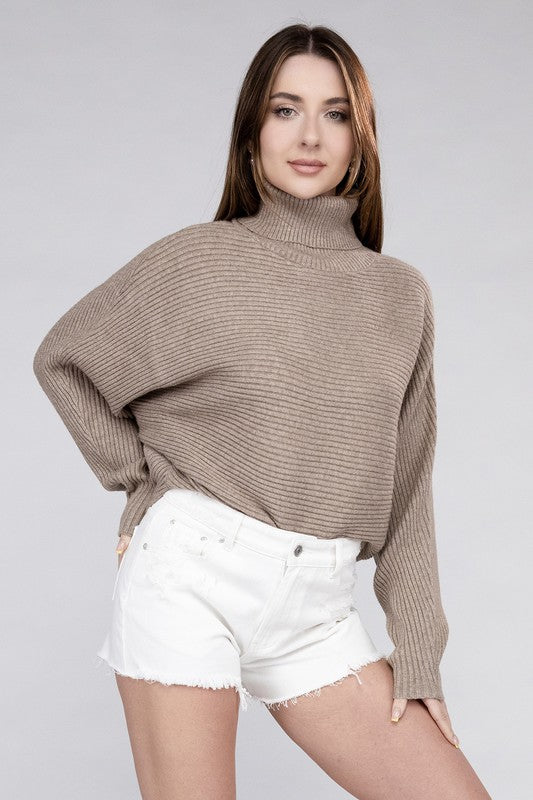 Hot coco loose fitting turtleneck sweater, with ribbed knit texture, dolman sleeves, and raw hem detailing.