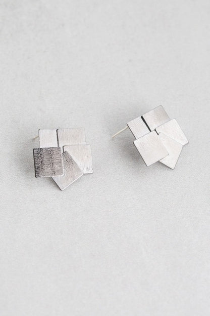 Flat lay of Square Deal Earrings showing layered geometric design.
