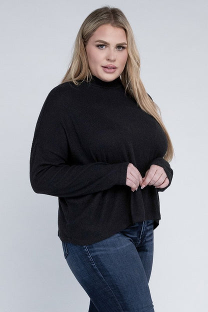 Plus size model wearing Raya Curvy Plus Drop Shoulder Top in black with mock neck, front view.