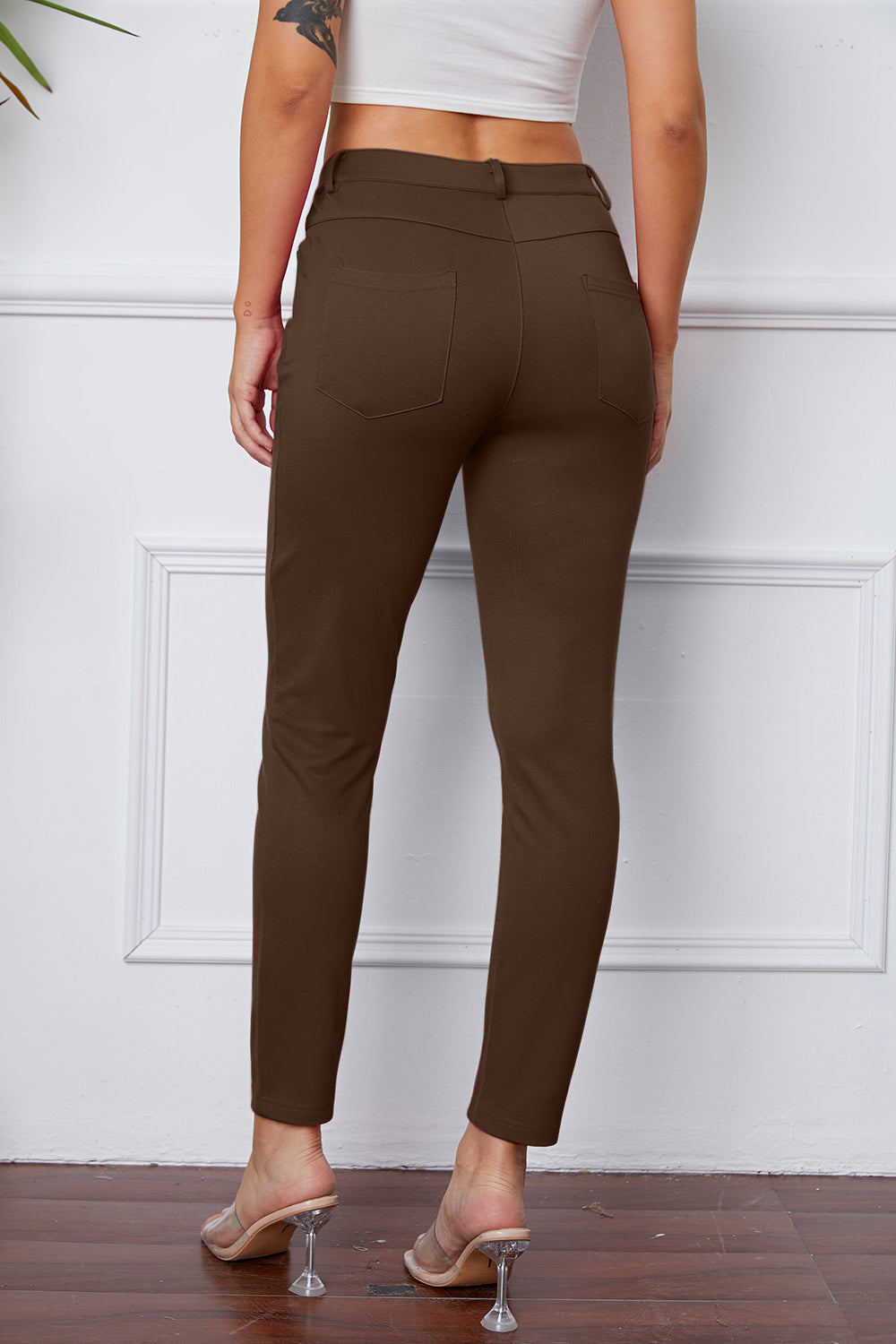 Coffee Brown stretchy high-waisted pants feature pockets, a zip fly, and belt loops. 