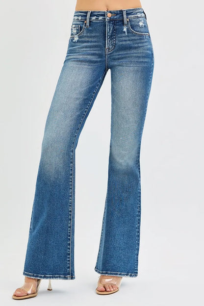 Model wearing Jordy Tummy Control High Rise Flare Jeans in dark wash with flattering fit.