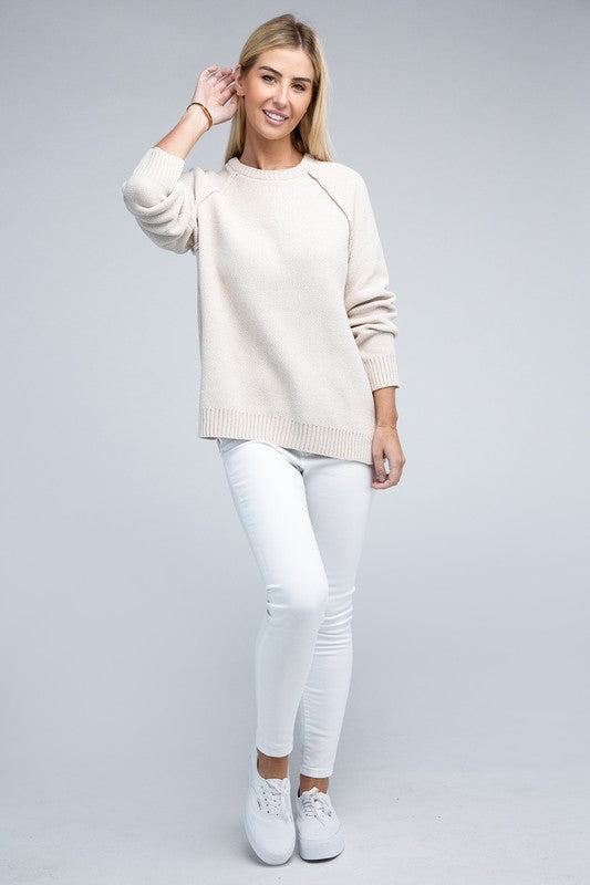 Sand beige round neck chenille sweater with long raglan sleeves, relaxed fit, and hip-length cut.