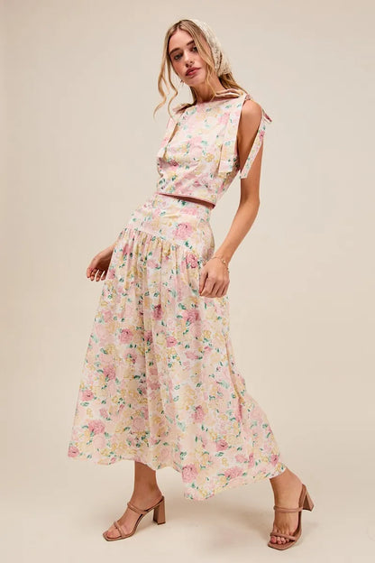 Side view of Soraya Floral Two-Piece Set with bow-tied straps and flowing pink floral tiered maxi skirt.