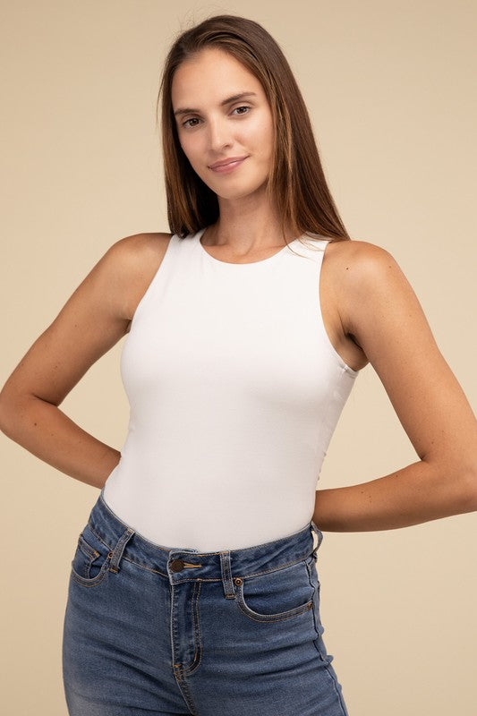 Sleeveless bodysuit in bone with a boat neckline, padded bodice, and removable bra pads for adjustable comfort.