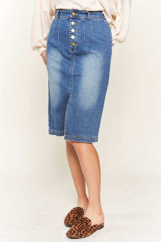 Denim button-down midi skirt with a front slit, belt loops, and back pockets. Features a high waist with an elasticized waistband in the back.