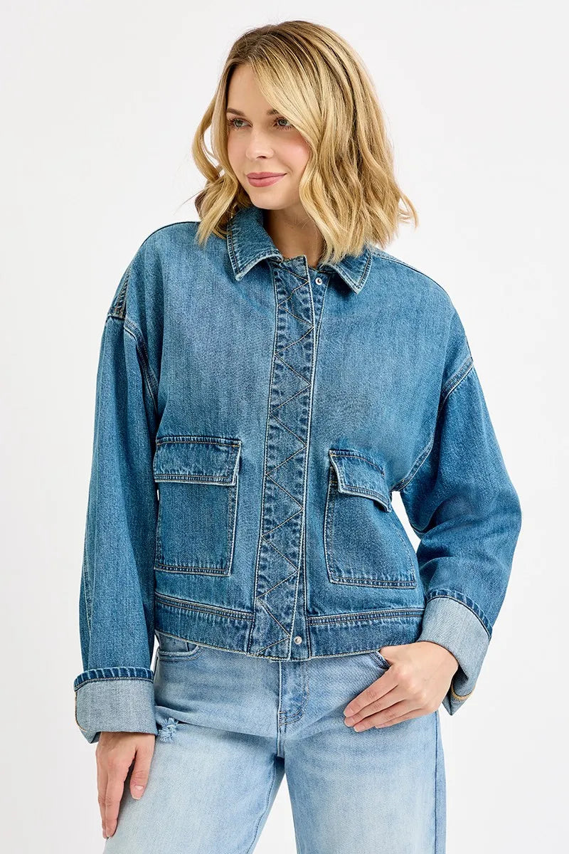 Blue oversized collared denim jacket with pocket details and no-stretch fabric for sturdy structure.