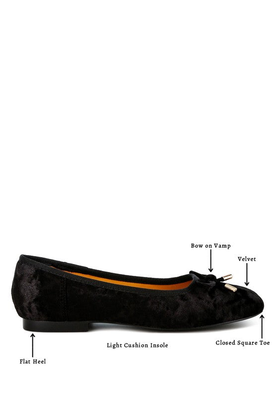 Black velvet ballerina flats with a closed square toe, bow detail on the vamp, and cushioned insoles for comfort.