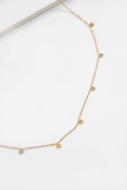 Close-up flat lay of Golden Dot Charm Necklace showing tiny gold discs